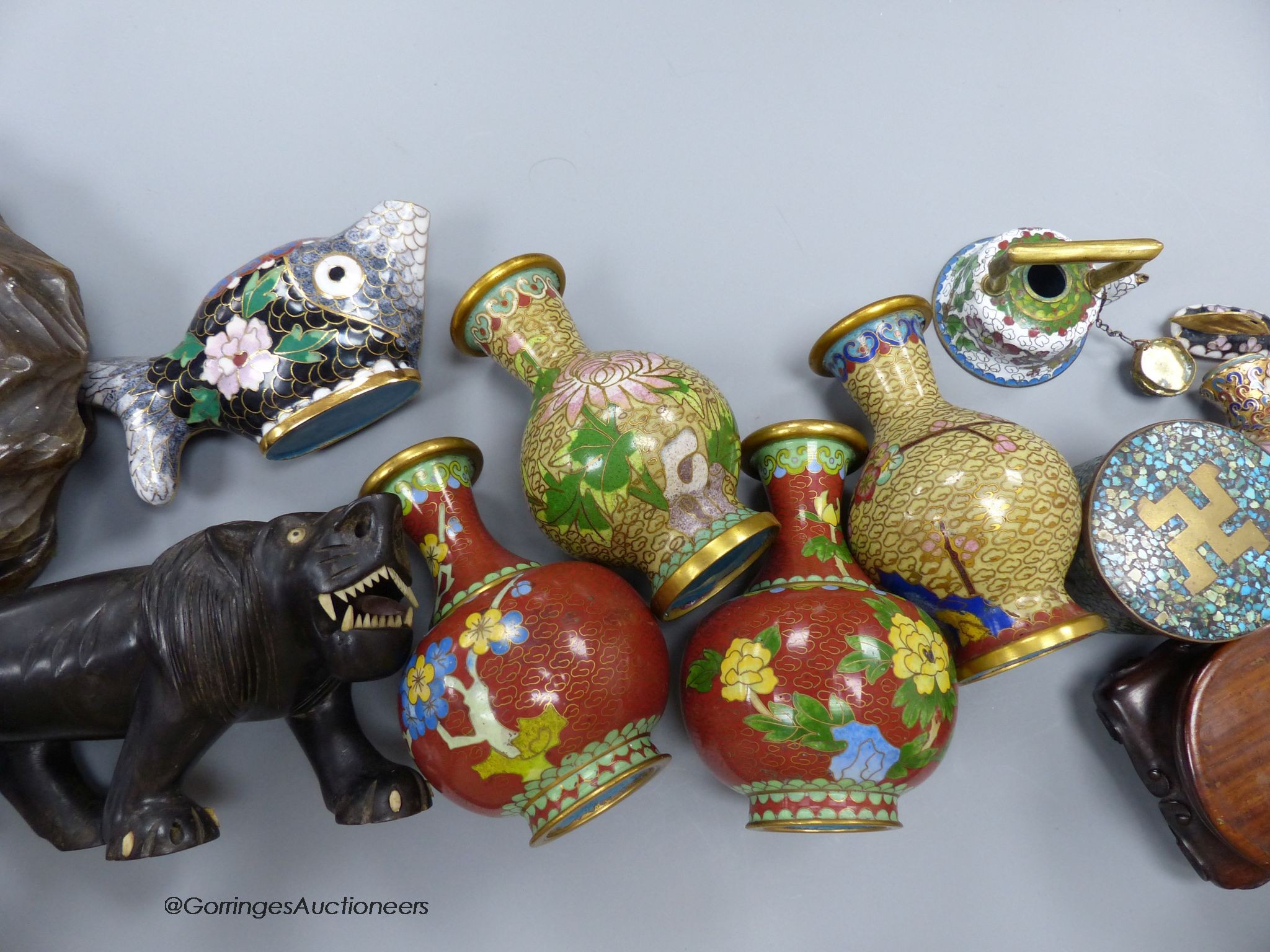 A group of Chinese or Japanese wood stands and cloisonne enamel vases